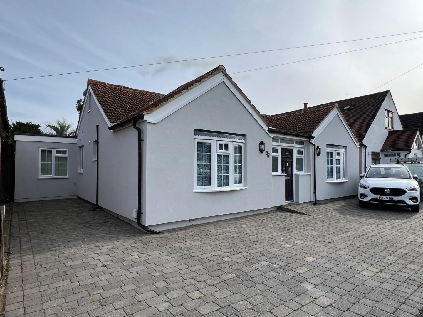 A rendered bungalow finished in a clean off white silicone render