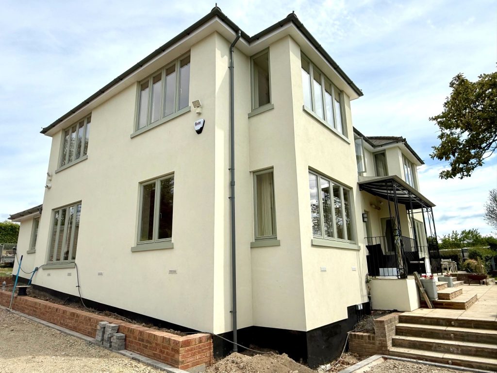 Close view of a cream silicone render finish showing the fine texture